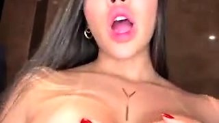 Busty babe playing with her big boobs