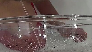 A MILF in Red Is Peeing Into a Basin.