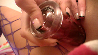 Brunette in purple fishnets fucking her pussy with toy