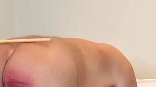 Young domme canes her slave