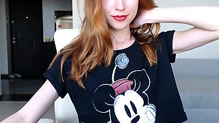 Sexy redhead camgirl exposes her slim body and tight peach