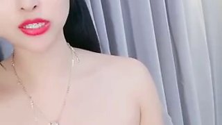 Asian girl with small tits solo toys her pussy with vibrator