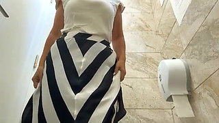 Mature milf with big ass and big tits masturbates in public toilet until orgasm