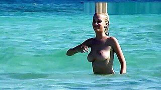 Topless blonde with big boobs on the beach showing tits in public!