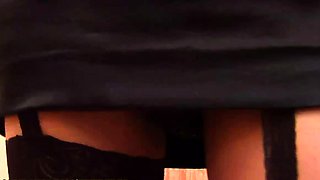 Busty brunette ladyboy in black lingerie strokes her hairy