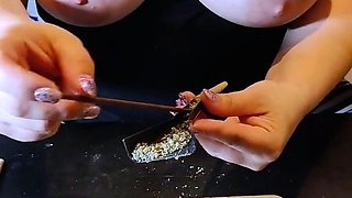 Big tit step mom rolls a joint with her tits out